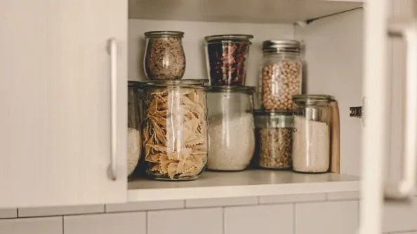 Organize the kitchen by decluttering and using containers for your items.